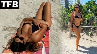 Claudia Romani Shows Off Her Curves on the Beach on picsfans.net